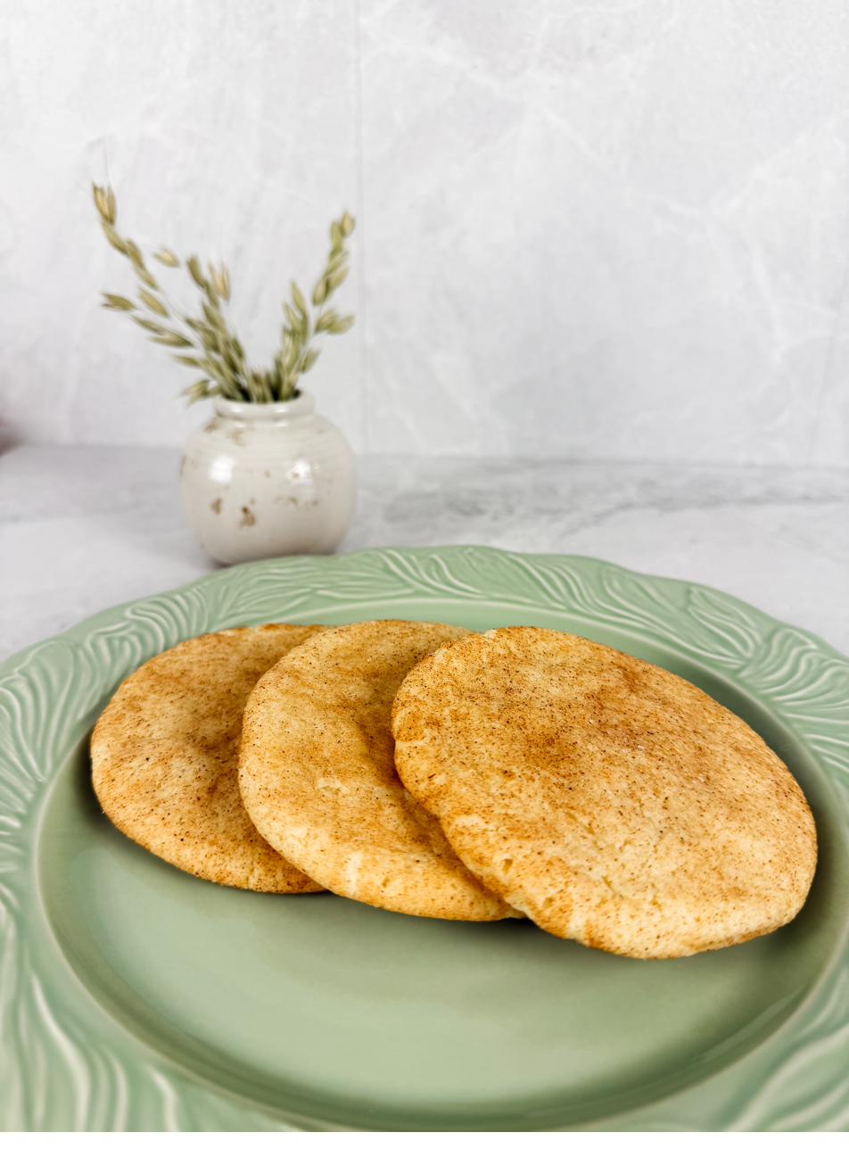 Brown butter snickerdoodles fanned across a pale green plate