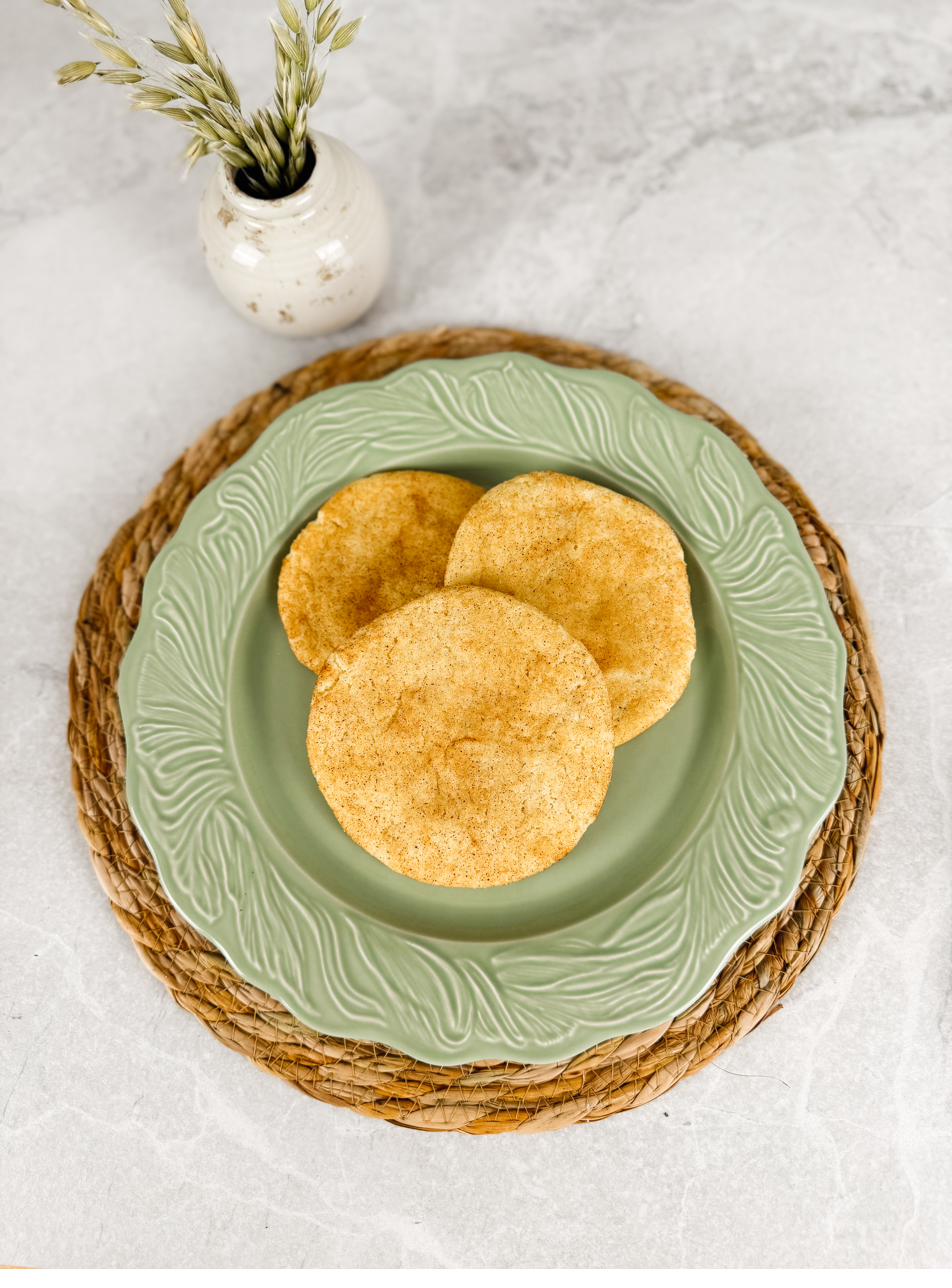 Three cinnamon-sugar snickerdoodles on a pale green plate