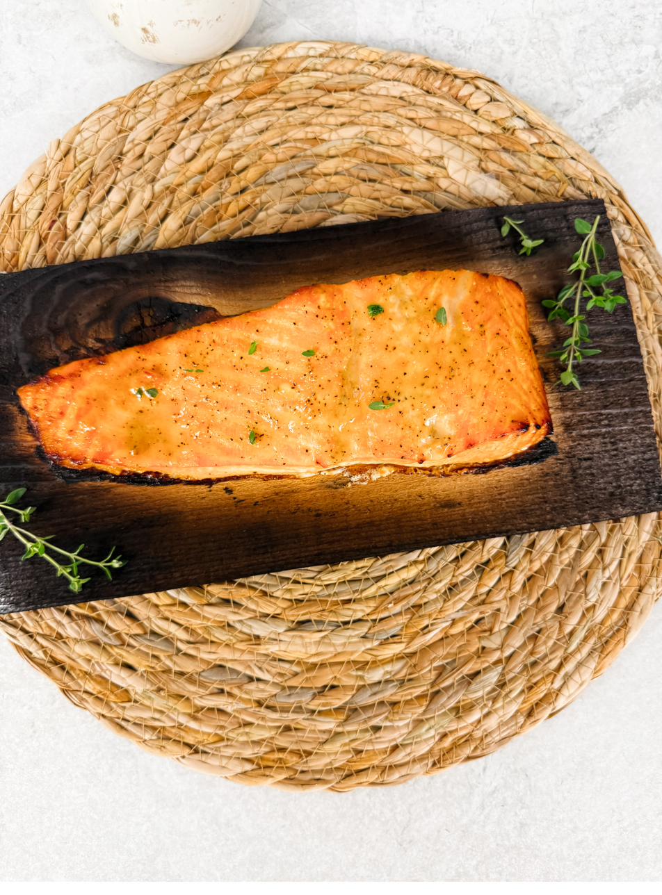 Salmon on a charred cedar plank with fresh thyme