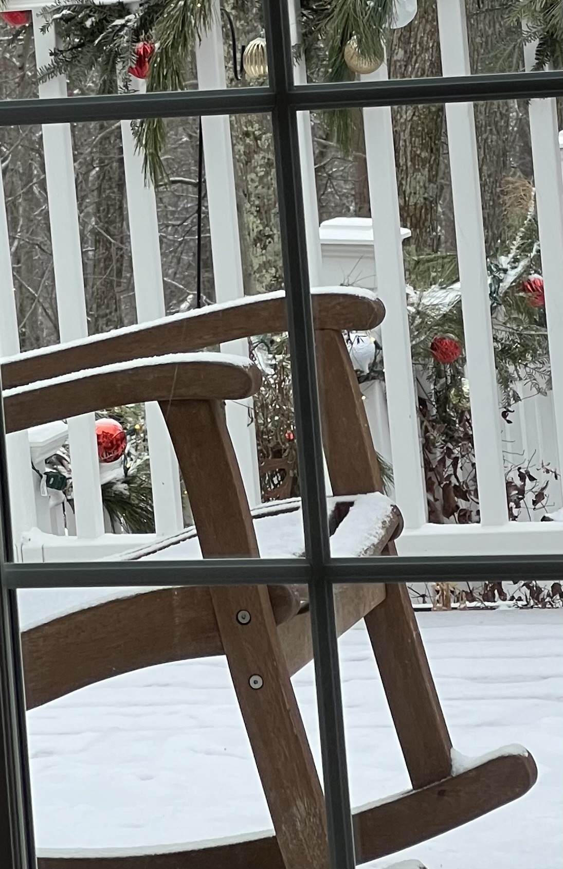 A snow-covered chair seen through the window