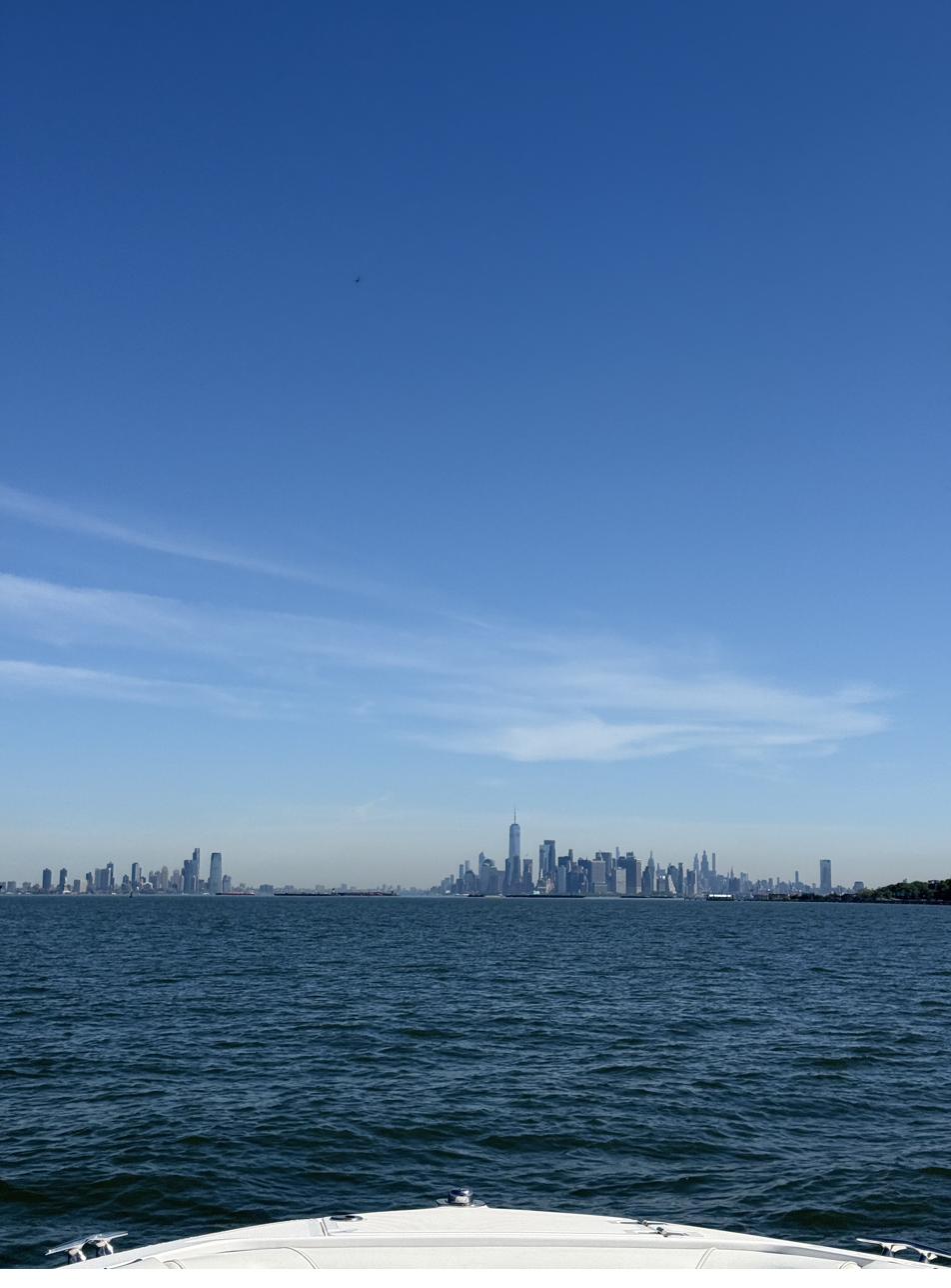 The Manhattan skyline seen in the distance from a boat on the harbor