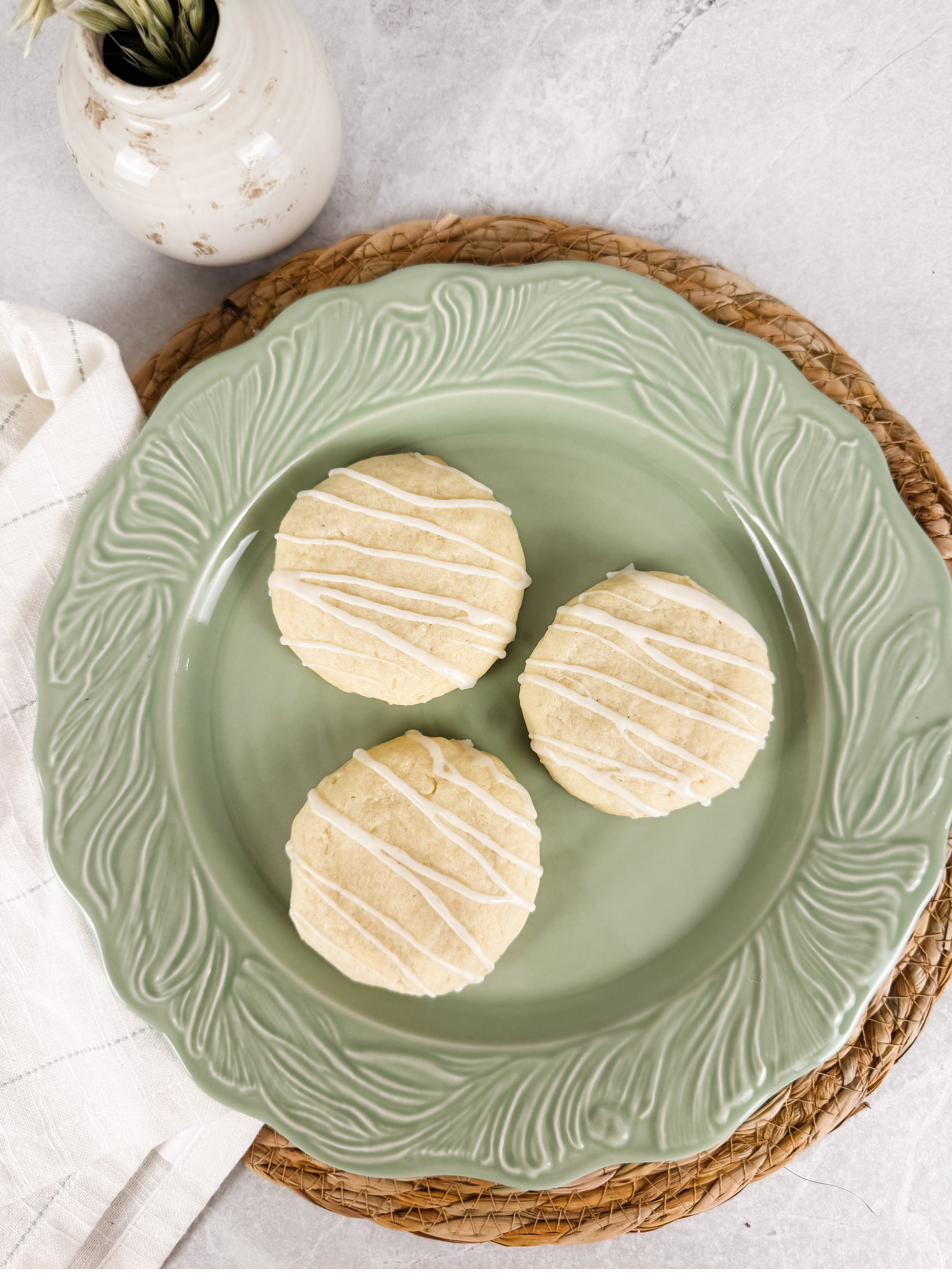 Glazed vanilla bean sugar cookies seen from above on a pale green plate